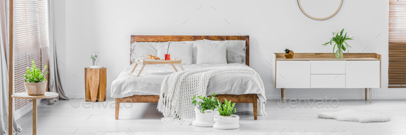 Panorama of a bright white and wooden bedroom interior with doub - Stock Photo - Images
