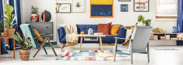 Panorama of a colorful living room interior with a gallery of po Stock Photo by bialasiewicz