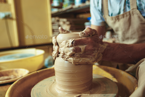 Creating a jar or vase of white clay close-up. Master crock. Man hands making clay jug macro. - Stock Photo - Images