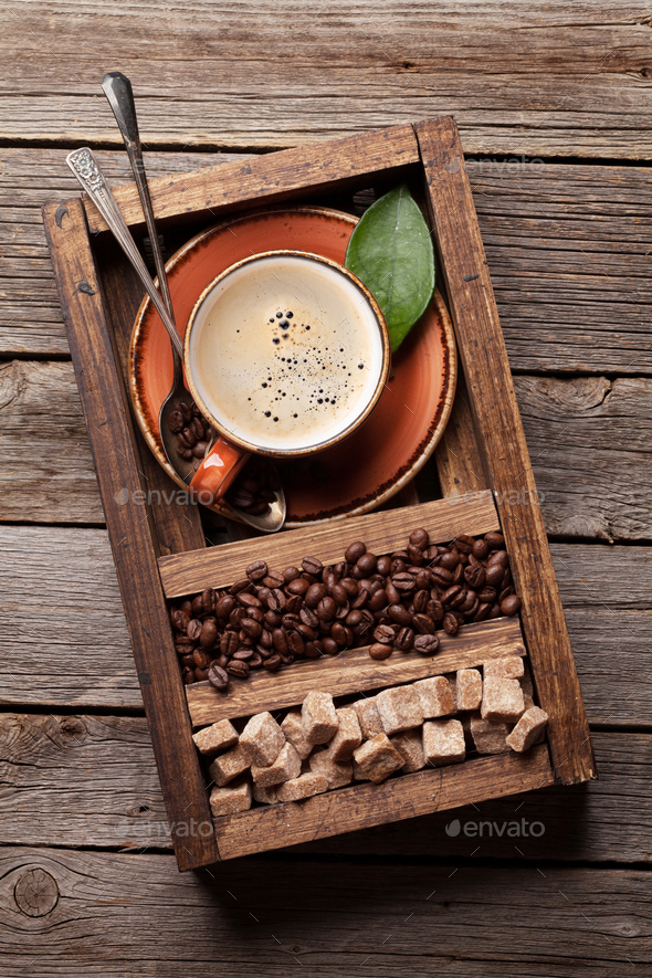 Coffee cup, roasted beans and brown sugar Stock Photo by karandaev
