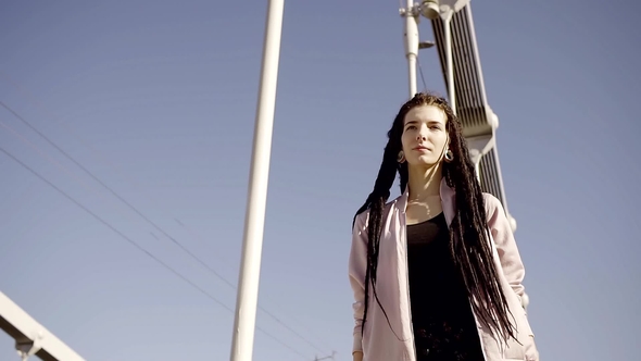 Portrait of Beautiful Young Woman Walks Across Street in the City on a Beautiful Windy Day alt