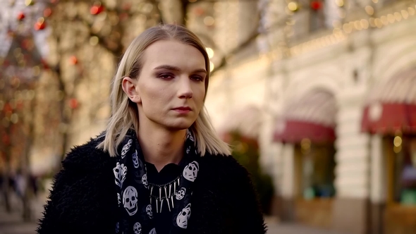 Cute Gay Boy Takes Place on a Christmas Background and Smoking a Cigarette alt