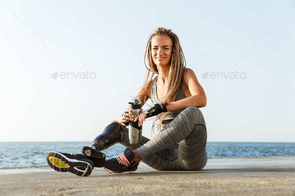 Smiling disabled athlete woman with prosthetic leg Stock Photo