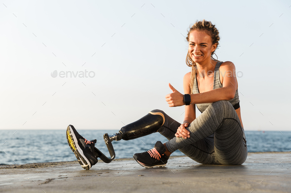 Attractive disabled athlete woman with prosthetic leg Stock Photo by  vadymvdrobot