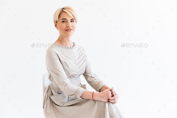 Portrait of pretty mature woman with short blond hair wearing dr - Stock Photo - Images