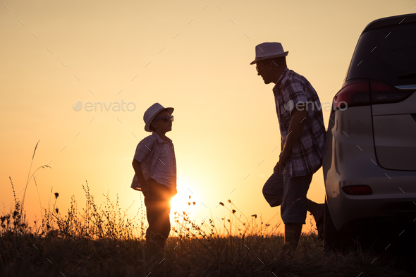 Father and son playing in the park at the sunset time. - Stock Photo - Images