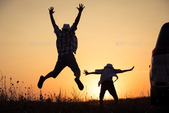 Father and son playing in the park at the sunset time. - Stock Photo - Images