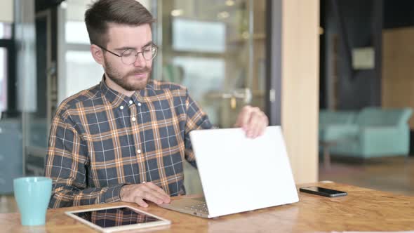 Young Male Designer Standing Up and Going Away alt