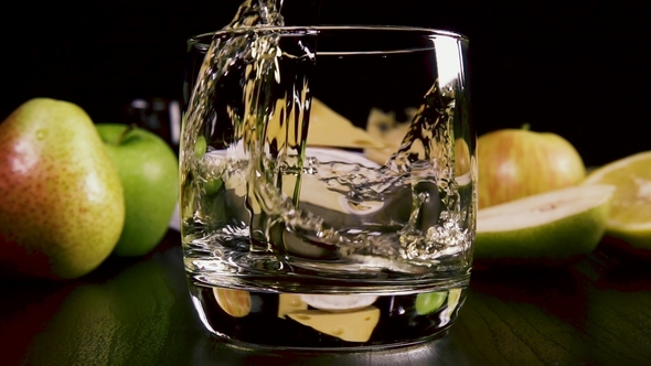 Strong Alcoholic Drink Pour Into a Glass Near the Snack