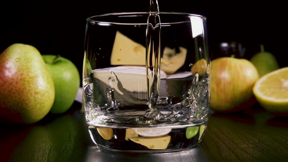 Strong Alcoholic Drink Pour Into a Glass Near the Snack