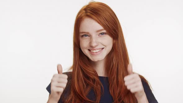 Smiling Beautiful Redhead Caucasian Teenage Girl Showing Ok with Two Thumbs on White Background in alt