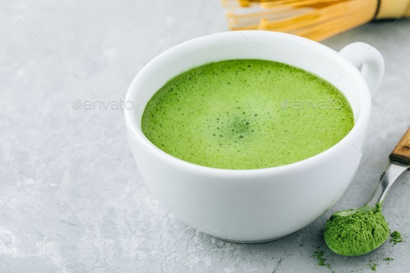 Japanese matcha green tea latte in white cup on gray background Stock Photo  by nblxer