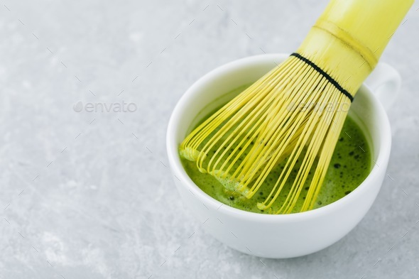 Japanese matcha green tea latte in white cup on gray background Stock Photo  by nblxer