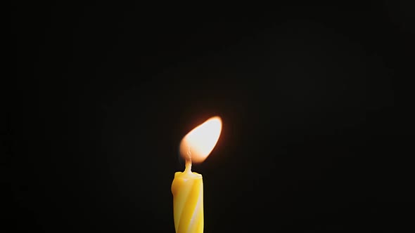 Flames Burning in the Dark Candle Macro Closeup Against a Dark Background Slow Motion alt