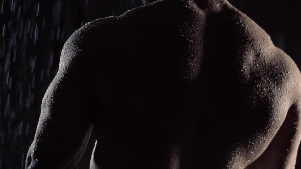 Alone Bodybuilder Is Standing in a Shower, Camera Is Moving From Lower Part of His Muscular Back alt