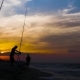 Fisherman Using Fishing Rod for Catch Fish in Sea on Beautiful Sunset in Sky - VideoHive Item for Sale