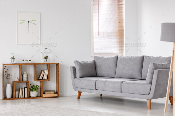 Real photo of a scandi living room interior with gray settee sta - Stock Photo - Images
