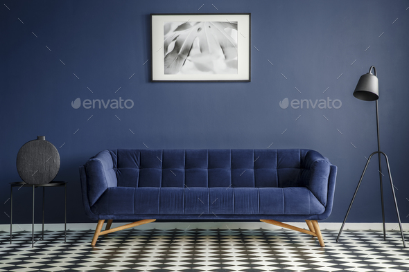 Navy blue room interior with comfortable plush couch in the midd Stock Photo by bialasiewicz