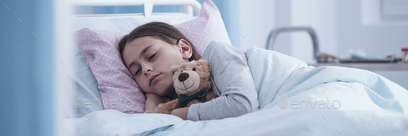 Panorama portrait of a sick little girl sleeping in a hospital b Stock Photo by bialasiewicz
