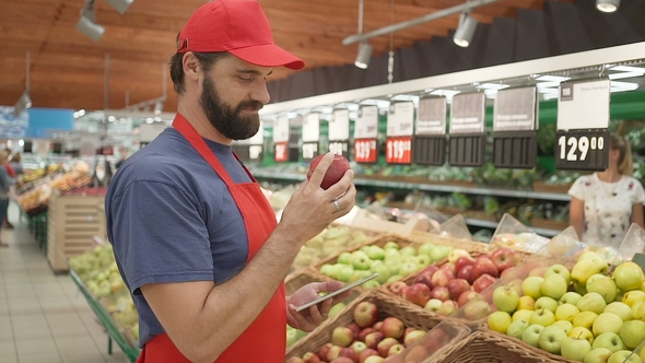 Supermarket Clerk Checking Quality of Apples, Freshness and Top Quality Food Concept