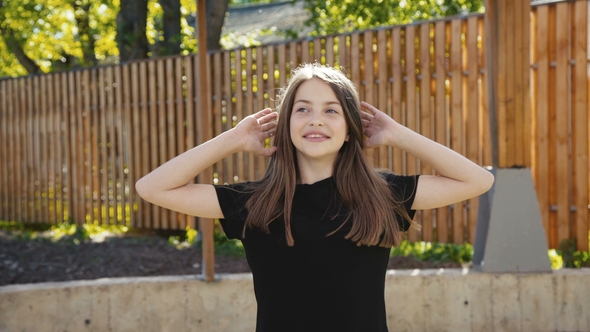 Young Funny Girl Walks with Poses on the Manege at Camera. alt