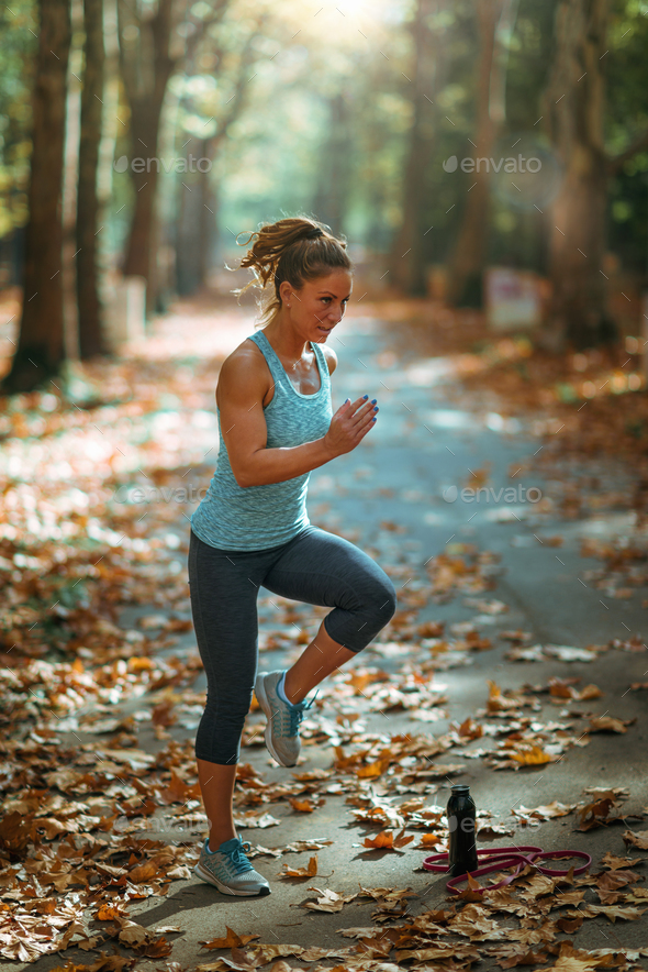 Woman Exercising Outdoors in The Fall Stock Photo by microgen | PhotoDune