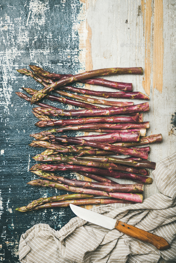 Fresh purple asparagus over rustic wooden background, vertical composition - Stock Photo - Images