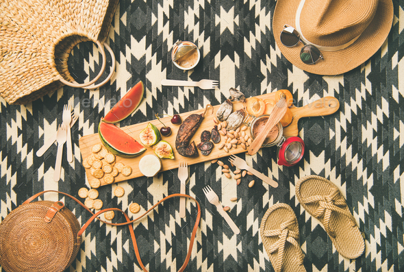 Picnic concept with sausage, fruit, cheese, pate and straw accessories - Stock Photo - Images