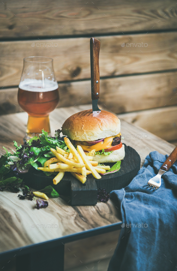 Classic burger dinner with glass of beer and french fries Stock Photo by sonyakamoz
