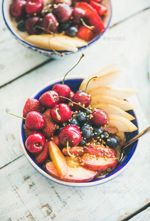 Healthy smoothie bowl with fruit and berries over wooden background - Stock Photo - Images