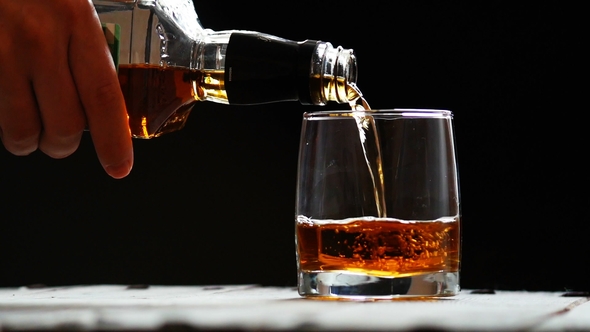 Glass with Ice and Scotch Whiskey on Wooden Glass alt