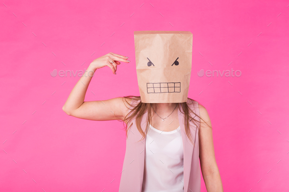 Concept of negative emotions - Angry woman with a paper bag on his face. Stock Photo by Satura_