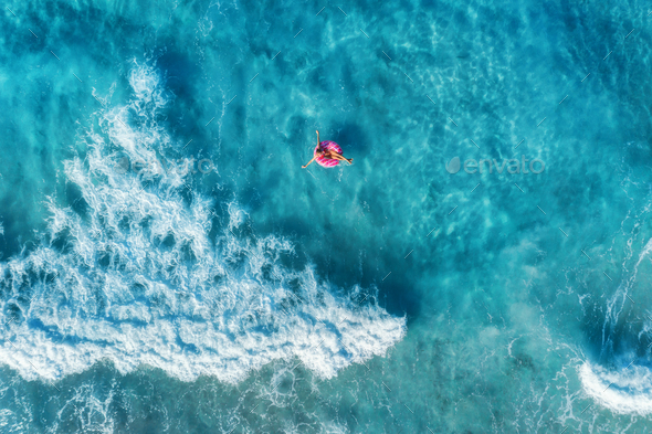 Aerial view of woman in the sea with waves - Stock Photo - Images