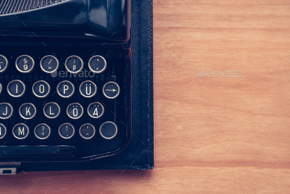 Vintage typewriter machine on writers desk - Stock Photo - Images