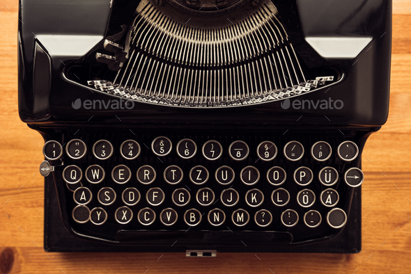 Vintage typewriter machine on writers desk - Stock Photo - Images