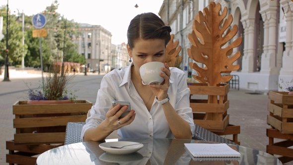 Woman Texting.  Young Happy Smiling Cheerful Beautiful Girl Looking at Mobile Cell Phone Readin alt