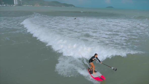 Aerial View From Above Athletic Young Women and Men Surf, Ride Big Waves with Bright Daylight alt