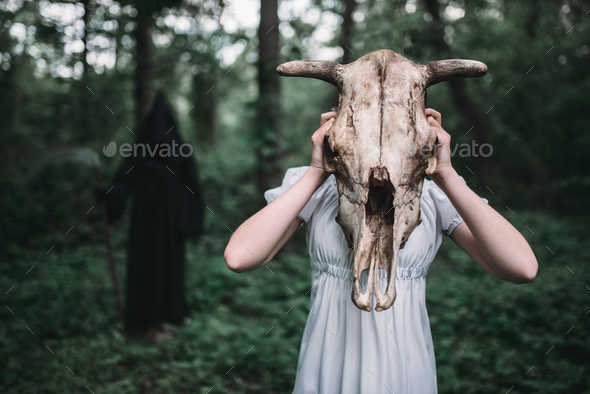 Victim and death in a black hoodie and with scythe - Stock Photo - Images