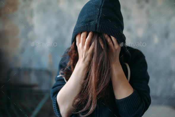Female in a hoodie holds her head Stock Photo by NomadSoul1 | PhotoDune