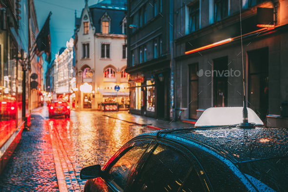 Taxi Car Wait Clients In Old European Streets In Rainy Evening. Stock Photo by Grigory_bruev