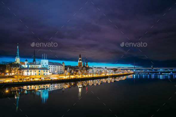 Riga, Latvia. Cityscape In Evening Dusk Time. Night View Of Cast - Stock Photo - Images