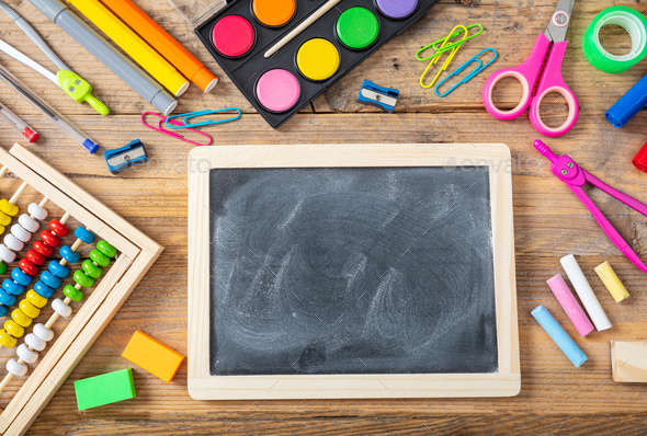 Back to school. School supplies and blank chalkboard on wooden background, space for text Stock Photo by rawf8