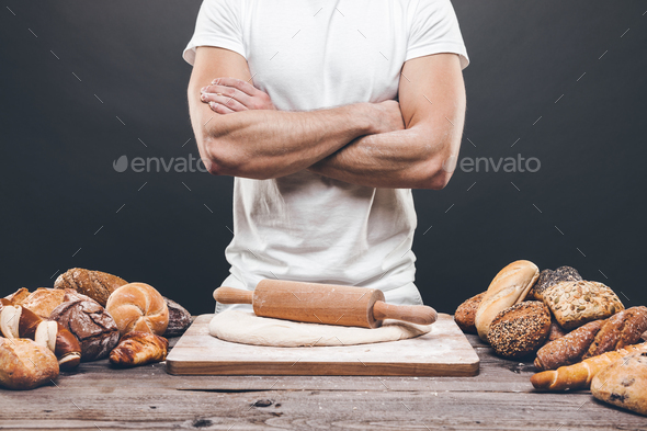 Baker with a variety of delicious freshly baked bread and pastry Stock Photo by tommyandone