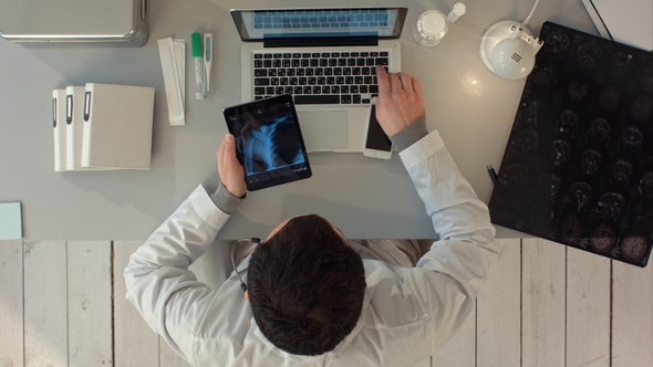 Man Using Tablet Pc Against Medical Xray alt