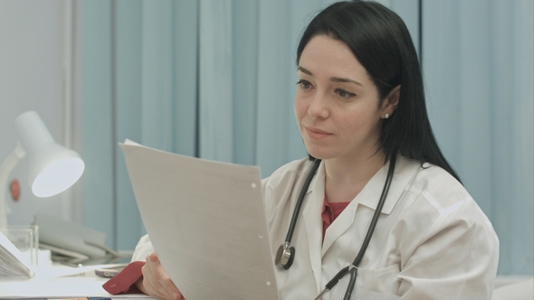 Doctor Analyzing Results an Electrocardiogram alt