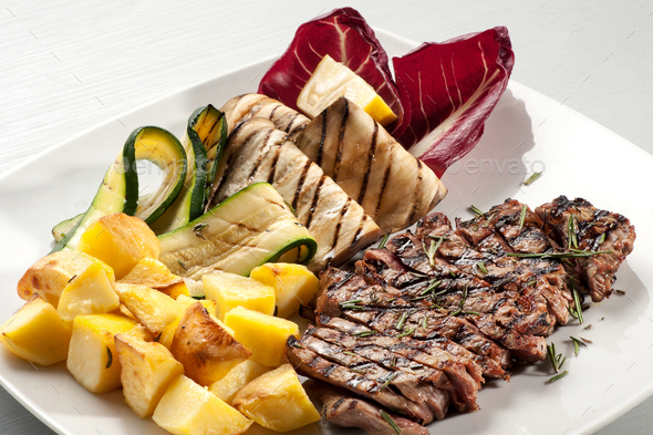 Grilled beef steak seasoned with fresh herbs - Stock Photo - Images