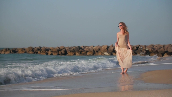 Blonde Woman Is Walking Near Sea in Summer Day Stepping on Wet Sand By Her Bare Feet