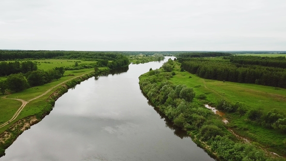 Flying Over the River Flowing Along the Fields and Forests alt