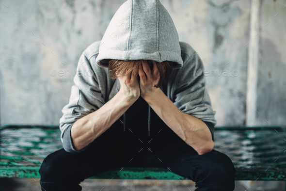 Junkie sitting on the bed, withdrawal symptom - Stock Photo - Images