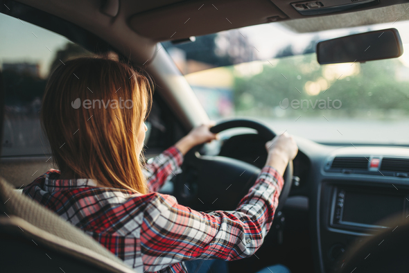 Young woman beginner driving a car, back view Stock Photo by NomadSoul1